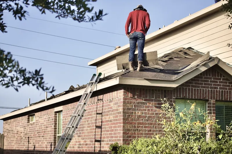 Professional roofer working on a residential roof in Sycamore Farms